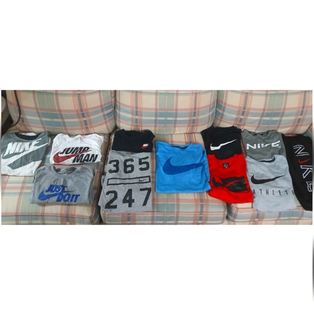 YL Nike shirts and a pair of YL Nike swimming trunks